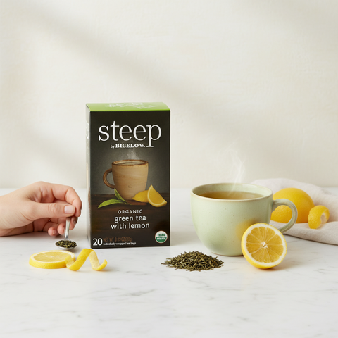 Bean Here Bean There Coffee & Cocoa Steep by Bigelow organic green tea with lemon box, tea cup, and fresh lemon slices