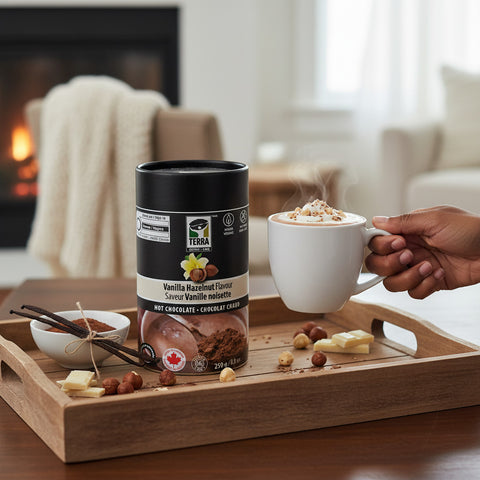 Bean Here Bean There Coffee & Cocoa Terra Vanilla Hazelnut hot chocolate tin with a steaming mug on a wooden tray.